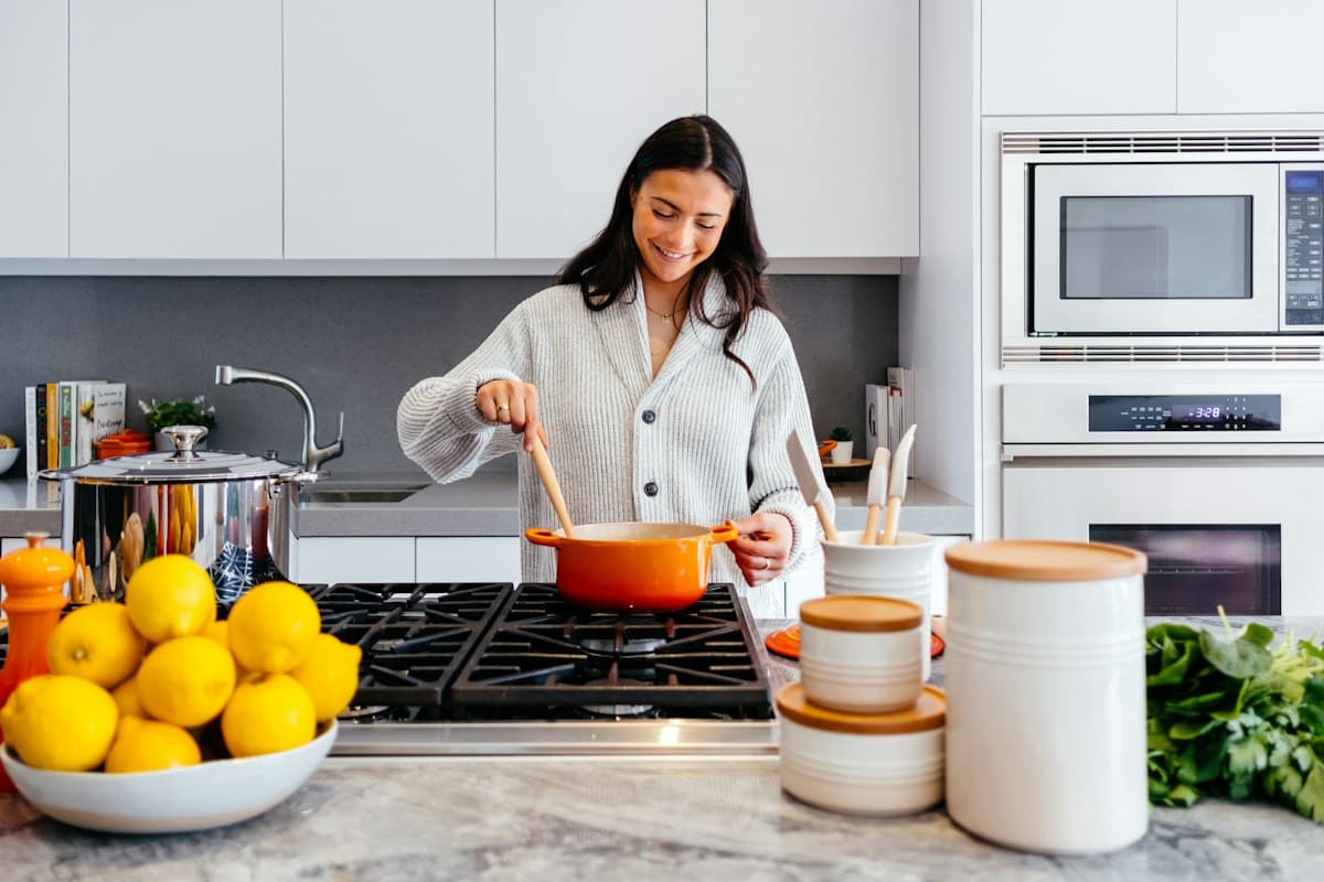 Clean warm kitchen countertop with Japanese magnetic wooden knife block and handmade ceramic crock
